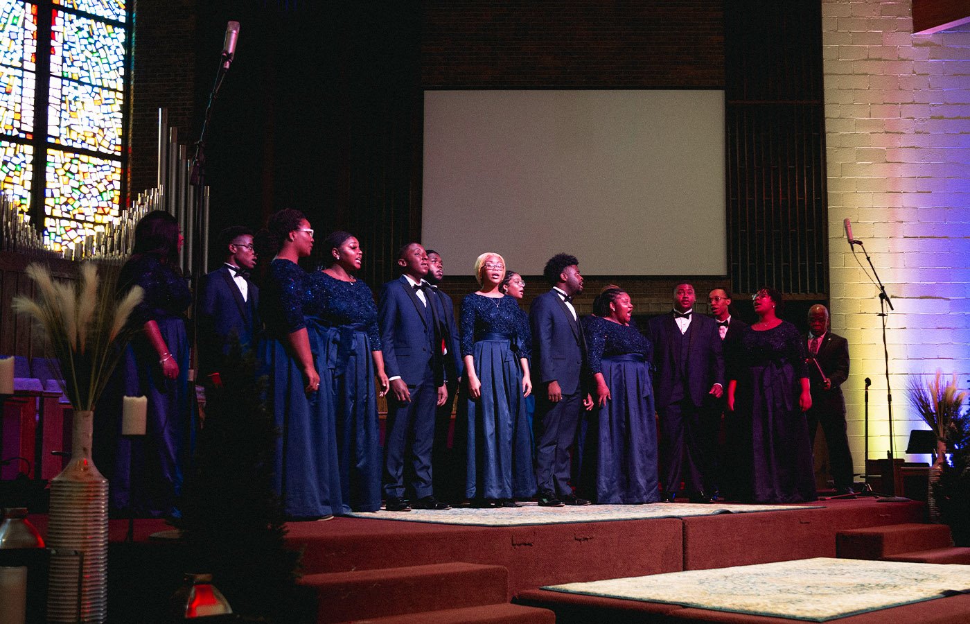 A worship choir sings on stage.