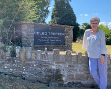 Jera Tidball poses with the Coleg Trefeca sign.