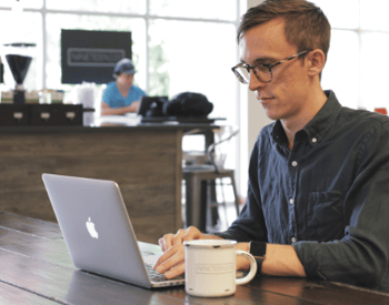 Student accesses his Trevecca courses via his laptop in a café.