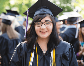 Trevecca undergraduate wears her graduation hat and honors cords for Commencement.