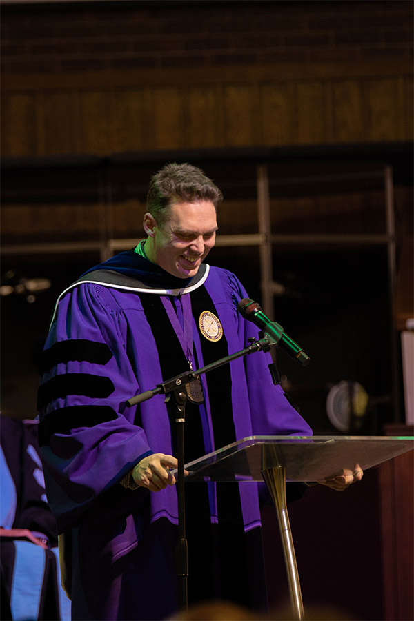 Tim gains giving a message at the undergraduate teaching excellence chapel